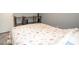 Comfortable bedroom with a floral-patterned comforter and a wooden shelf at 2110 Churchill Downs Cir, Orlando, FL 32825