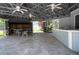 A well-equipped cabana with picnic table, outdoor grill, and ceiling fans offer an escape from the sun at 2110 Churchill Downs Cir, Orlando, FL 32825