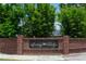 Brick sign welcomes you to Surrey Ridge, surrounded by lush landscaping and a glimpse of the neighborhood beyond at 2110 Churchill Downs Cir, Orlando, FL 32825