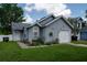 Charming single-story home with gray siding, attached garage, and well-maintained front yard with landscaping at 2110 Churchill Downs Cir, Orlando, FL 32825