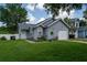 Inviting single-story home with attached garage, complemented by lush lawn and manicured landscaping at 2110 Churchill Downs Cir, Orlando, FL 32825
