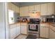 Charming kitchen with ample cabinet space and efficient appliance arrangement at 2110 Churchill Downs Cir, Orlando, FL 32825