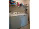 The laundry room features a washer, dryer, and shelving for efficient organization at 2110 Churchill Downs Cir, Orlando, FL 32825