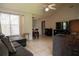 Cozy living room with tiled floors, vaulted ceiling and comfortable sectional sofa at 2110 Churchill Downs Cir, Orlando, FL 32825