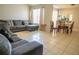 Open-concept living and dining area with tiled floors, creating a seamless flow at 2110 Churchill Downs Cir, Orlando, FL 32825