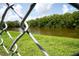 Enjoy the serene pond views through the metal fence, adding security and nature's beauty at 2110 Churchill Downs Cir, Orlando, FL 32825