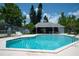 Community pool features a covered recreation area, bright blue water, and plentiful seating at 2110 Churchill Downs Cir, Orlando, FL 32825