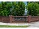 Close-up of the Surrey Ridge brick monument sign with mature landscaping at 2110 Churchill Downs Cir, Orlando, FL 32825