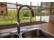 Stainless steel kitchen sink with views of the screened porch at 2110 Churchill Downs Cir, Orlando, FL 32825