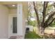 Close-up of the side of the house and decorative glass front door with stone accents at 2112 Waitman, Leesburg, FL 34748