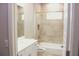 Stylish bathroom featuring a tiled shower/tub combo with a window and modern fixtures at 2114 Waitman Ave Waitman, Leesburg, FL 34748