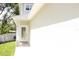 Close up of the front entry featuring a white door and stacked stone detail on the home's facade at 2114 Waitman Ave Waitman, Leesburg, FL 34748