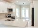 Modern kitchen with stainless steel appliances, white cabinets, and an eat-in island at 2114 Waitman Ave Waitman, Leesburg, FL 34748