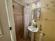 A convenient full bath is equipped with a shower and single sink vanity at 2122 Waseca Ln, Leesburg, FL 34748
