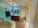 Bathroom with double sinks, an elegant light fixture, and ample storage space at 2122 Waseca Ln, Leesburg, FL 34748