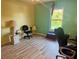 Bright bedroom with laminate flooring, neutral paint, and large window at 2122 Waseca Ln, Leesburg, FL 34748