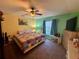 This cozy bedroom features a ceiling fan, ample natural light, and comfortable furnishings at 2122 Waseca Ln, Leesburg, FL 34748