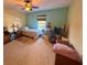 Comfortable bedroom with carpet, ceiling fan, and window at 2122 Waseca Ln, Leesburg, FL 34748