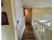 Hallway showcasing wood-look floors and access to storage and other rooms at 2122 Waseca Ln, Leesburg, FL 34748