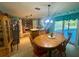 Inviting eat-in kitchen complete with an adjacent dining area and views of the screened pool at 2122 Waseca Ln, Leesburg, FL 34748