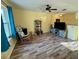 This living room offers wood-look flooring and a ceiling fan for added comfort at 2122 Waseca Ln, Leesburg, FL 34748