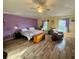 Spacious bedroom has wood-look floors and a comfortable seating area by the windows at 2122 Waseca Ln, Leesburg, FL 34748