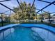 Refreshing screened-in pool area, perfect for outdoor relaxation and enjoying the serene backyard at 2122 Waseca Ln, Leesburg, FL 34748