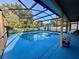 Inviting screened-in pool and patio area with stylish blue deck, perfect for relaxing outdoors at 2122 Waseca Ln, Leesburg, FL 34748