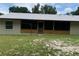 Back porch area with wood details and screened area, set against a serene natural backdrop at 2530 Shady Ln, Groveland, FL 34736