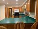 Kitchen area featuring oak cabinets, green countertops, and modern appliances at 2530 Shady Ln, Groveland, FL 34736