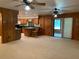 Open-concept living room with adjacent kitchen bar seating and sliding glass doors to the porch at 2530 Shady Ln, Groveland, FL 34736
