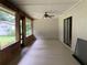 Enclosed patio featuring a ceiling fan and views of the backyard at 2530 Shady Ln, Groveland, FL 34736