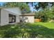 Back yard features a sliding glass door and plenty of green grass at 2708 Lorraine Dr, Leesburg, FL 34748