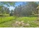 Expansive fenced backyard with lush greenery, offering privacy and outdoor enjoyment potential at 2708 Lorraine Dr, Leesburg, FL 34748