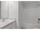 Bright bathroom features a clean vanity, toilet, and a bathtub-shower combo with modern fixtures at 2708 Lorraine Dr, Leesburg, FL 34748
