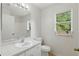 Bathroom featuring a well-lit mirror, vanity, toilet, and a window providing natural light and ventilation at 2708 Lorraine Dr, Leesburg, FL 34748