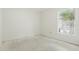 Bright bedroom with a window offers natural light, awaiting personalization for flooring and decor at 2708 Lorraine Dr, Leesburg, FL 34748