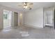 Bedroom featuring a ceiling fan and three doors to closets or an en-suite bathroom at 2708 Lorraine Dr, Leesburg, FL 34748