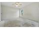 Spacious bedroom featuring a ceiling fan and a large window at 2708 Lorraine Dr, Leesburg, FL 34748