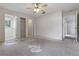 Bright bedroom featuring a ceiling fan, closet, and bathroom, offering a comfortable living space at 2708 Lorraine Dr, Leesburg, FL 34748
