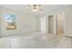 Spacious bedroom featuring a ceiling fan, a large window, and multiple closets at 2708 Lorraine Dr, Leesburg, FL 34748