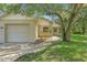 Charming single-story home with a well-manicured lawn and an attached one-car garage at 2708 Lorraine Dr, Leesburg, FL 34748