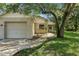 Close up front exterior featuring a well-maintained lawn and mature trees at 2708 Lorraine Dr, Leesburg, FL 34748