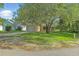 Well-maintained home with a green front yard and private driveway, situated in a peaceful neighborhood at 2708 Lorraine Dr, Leesburg, FL 34748