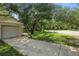 Large shade tree covering the front yard and long driveway at 2708 Lorraine Dr, Leesburg, FL 34748