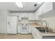Eat-in kitchen features neutral-toned floors, white appliances, and ample counter space at 2708 Lorraine Dr, Leesburg, FL 34748