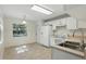 Eat-in kitchen features neutral-toned floors, white appliances, and ample counter space at 2708 Lorraine Dr, Leesburg, FL 34748