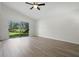 Bright living room with high ceilings, new light-colored floors, and sliding glass doors to the backyard at 2708 Lorraine Dr, Leesburg, FL 34748