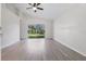Bright living room with high ceilings, new light-colored floors, and sliding glass doors to the backyard at 2708 Lorraine Dr, Leesburg, FL 34748