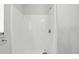 All-white tiled shower with sleek chrome hardware, offering a clean and modern bathing experience at 2708 Lorraine Dr, Leesburg, FL 34748